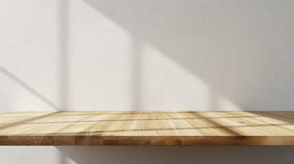 An empty wooden table against a white concrete wall with shadows from the window