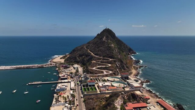 Drone flying toward the lighthouse on the Creston island, in sunny Mazatlan, Mexico