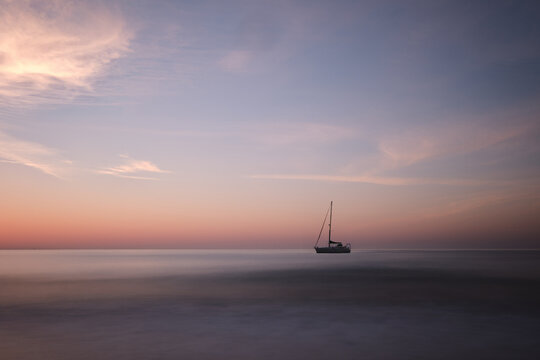 Long exposure shot of a boat at sea in Almunecar, Spain during the morning