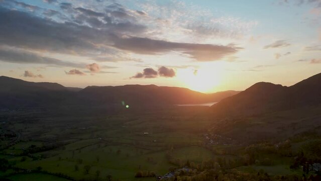 4k timelapse of the sun setting behind the hills overlooking Keswick in Cumbria, UK