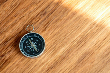 Compass on wooden background with copy space using as direction