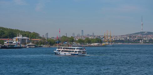 Touristic sightseeing ships in Golden Horn bay against blue sky and clouds. Istanbul, Turkey. During sunny summer day.