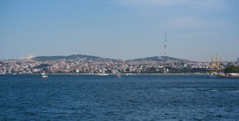 Fototapeta premium Touristic sightseeing ships in Golden Horn bay against blue sky and clouds. Istanbul, Turkey. During sunny summer day.