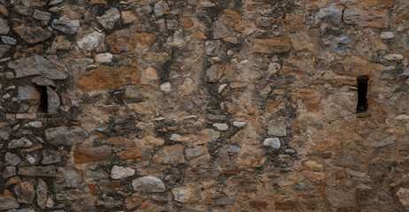 The texture of the stone wall. Old castle stone wall texture background. Stone wall as background or texture. Part of a stone wall, for background or texture.