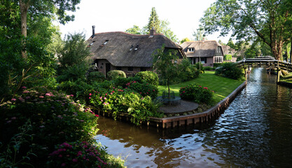 Typical houses of Giethoorn, Netherlands with gardens. Town is know as 