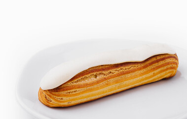Delicious classic eclair on white plate