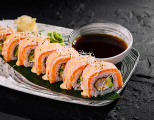 Fresh salmon sushi roll platter with dipping sauce