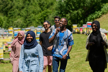 A diverse group of young friends and entrepreneurs explore small honey production businesses in the natural setting of the countryside.