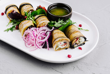 Gourmet eggplant rolls with fillings on elegant plate