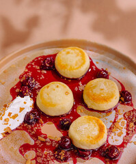 Gourmet cheese pancakes with berry sauce