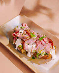 Gourmet open-faced ham sandwich on artisan bread