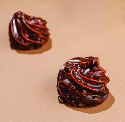 Artistic chocolate swirls on beige background