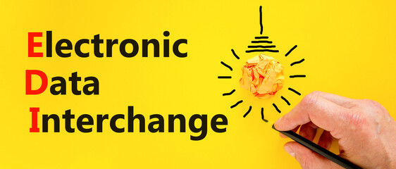 EDI electronic data interchange symbol. Concept words EDI electronic data interchange on yellow paper. Beautiful yellow background. Business and EDI electronic data interchange concept. Copy space.