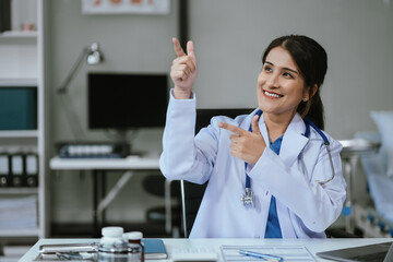 Happy female doctor presenting or pointing, happy working.