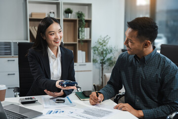 Automotive Business, Car Sale or Lease Concept: Car Dealership and sign contracts in car showrooms or car dealership offices.