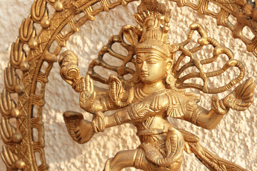 Bronze or gold statue of dancing Shiva. Tandava dance. Traditional Hindu religious figurine.