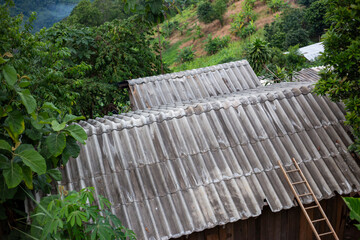 Selective focus tile roof of wooden house in mountain forest