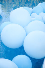 Large inflatable blue balls in the pool