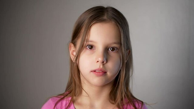 Portrait of a beautiful preschool child girl looking at camera, close-up