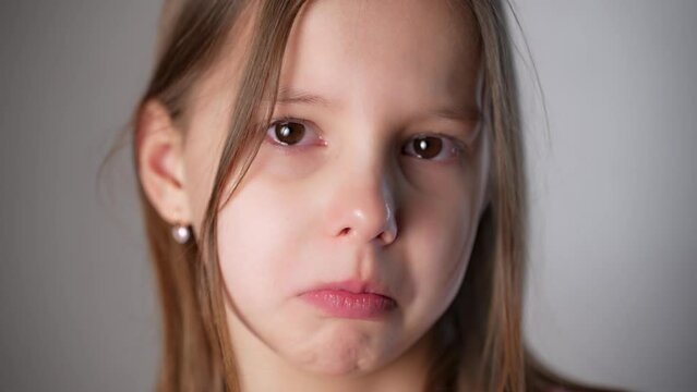 Close up upset cute girl looking sad crying on camera