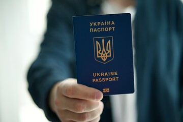 citizen of Ukraine with a Ukrainian passport in his hands