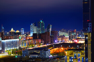 The center of the night city of Astana, illuminated by the light of houses, lanterns and car...