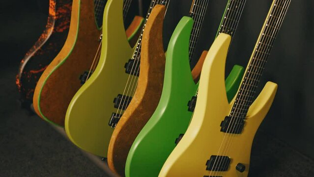 colorful electric guitars leaning on a wall in the studio. High quality 4k footage