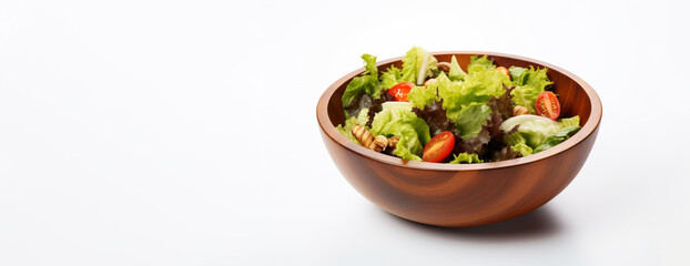 Set against a pristine white studio background, a wooden bowl showcases a colorful vegetable salad composed of tomatoes, cucumbers, lettuce, onions, olives, and bell peppers.