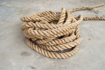 Fototapeta premium Close-up of a heart-shaped knot in a sturdy rope against a blurred background.. Beautiful simple AI generated image in 4K, unique.