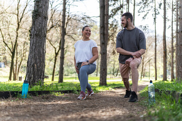 Naklejka premium A beautiful, overweight female and her friend enjoy to jogging in the park, then take time to stretch and cool down. 