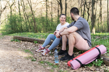 Sitting on a fallen tree trunk, the couple, including the determined overweight female, catch their...