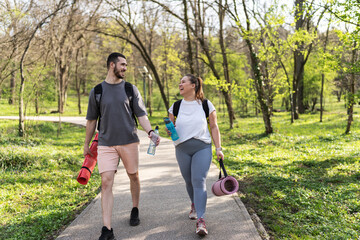 	
A young couple, including a beautiful overweight woman, heads to the park with enthusiasm, ready for an invigorating outdoor workout that promotes health and togetherness.	
