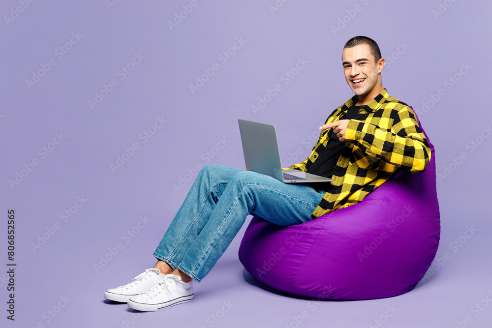 Sticker full body young it middle eastern man wear yellow shirt casual clothes sit in bag chair hold use wor