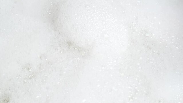 Foam bubble from soap or shampoo top view. Soap foam texture surface background. Detergent foam. Bathroom, clean, laundry, wash concept