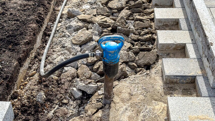 Jackhammer in footpath concept for renovation and landscaping