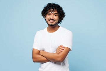 Young smiling cheerful confident happy Indian man he wear white t-shirt casual clothes hold hands...