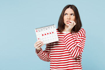 Young woman wear red casual clothes hold female periods pms calendar checking menstruation days...
