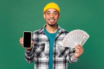 Young man of African American ethnicity wears shirt blue t-shirt hat hold fan cash money in dollar...