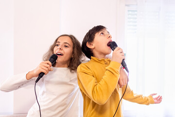 Children Singing into Microphones Together