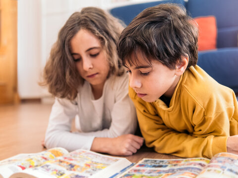 Children in Reading a Colorful Book Together