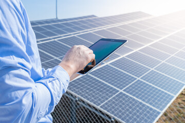 Close-up of a engineer checking solar panel setup. Using smart app in tablet. High quality photo