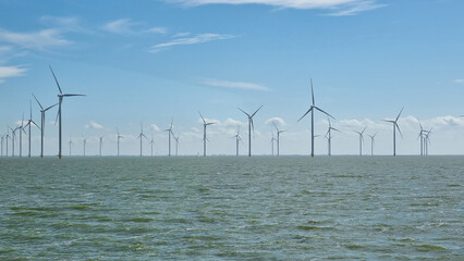 Windmills on large body of water