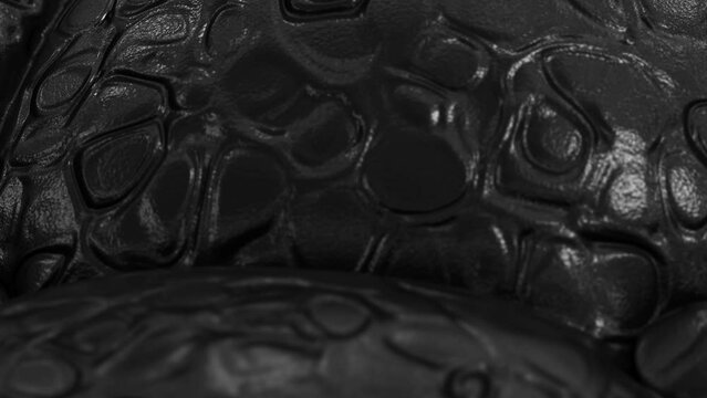 DOF zooming-out camera fly-over realistic 3D animation of the quilted black reptile leather or crocodile leather or eco-leather surface rendered in UHD
