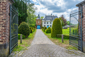 Rectory of the Sint-Martinus parish with iron gate, cobblestone driveway and beautiful garden,...