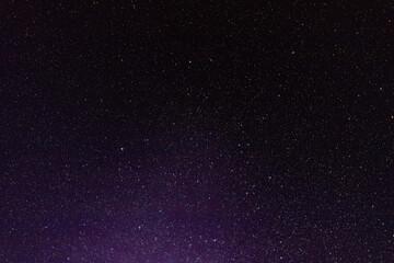 The sky with stars and the glow of the northern lights. Soft selective focus. Artificially created grain for the picture.