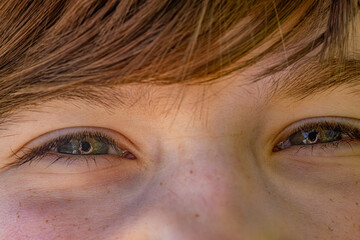 Close-up of the boy's eyes. The guy's face is happy.