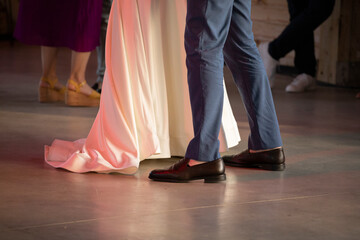 Close-up of dancers, low angle view woman and man on dance floor at ballroom. Wedding couple dancing