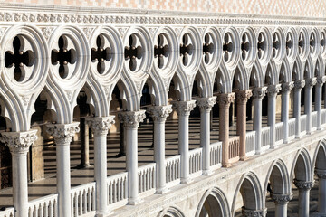 Architectural details and row of gothic columns of Doge's Palace at St Mark's Square in Venice,...