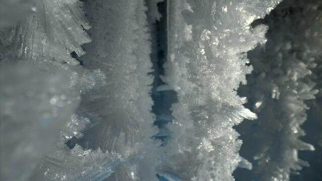 Sharp crystal icicles, ice snowflakes on stalactites inside frozen cave 