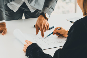 Architect and engineer working with construction drawing project on table in office. Architecture...